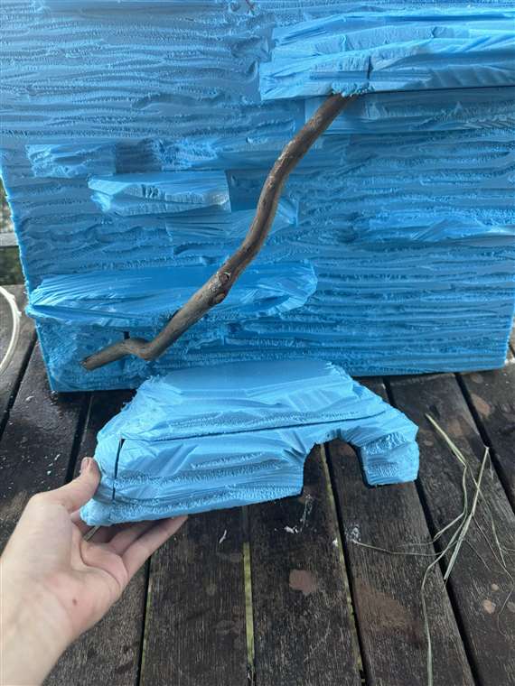 Blue foam backdrop and matching hide during the hand-shaping stage