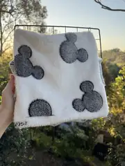 Front exterior view of a white and grey Oddball-made hanging hammock.